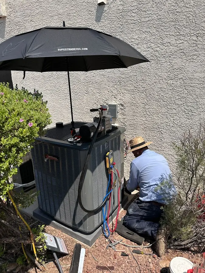 HVAC technician performing outdoor AC maintenance in Huron